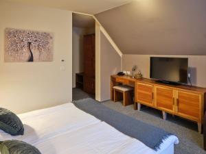 a bedroom with a bed and a flat screen tv at Hotel Boka in Bovec