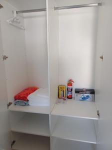 a white closet with shelves and a mattress at Cozy Cove in Cape Town