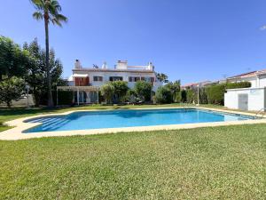 a large swimming pool in front of a house at La casilla de Miguel con jardín privado y piscinas in Denia