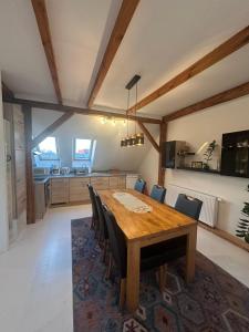 a dining room with a wooden table and chairs at Gemütliche Wohnung in Burg in Burg bei Magdeburg
