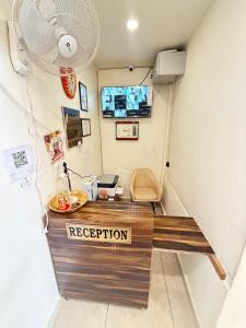 a reception desk in a room with a sign on it at GRACE Inn in Dehradun