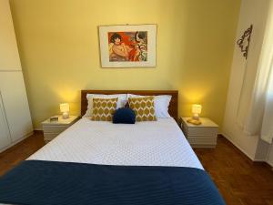 a bedroom with a large bed with two night stands at L' Atelier sui Tetti in Faenza