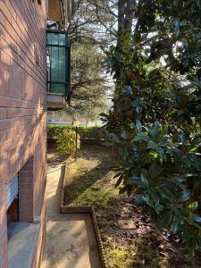 a brick house with a window on the side of it at Modern 90sqm Apt - Ideal Base for Parma & Modena in Cavriago