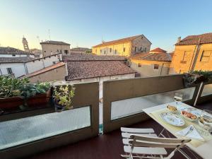 a view of a balcony with a table and chairs at L' Atelier sui Tetti in Faenza