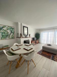 a living room with a table and chairs and a couch at Old Village in Vilamoura