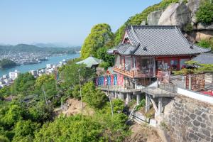 a house on the side of a mountain at 尾道つばめ堂 Onomichi Tsubamedo in Onomichi