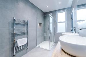 a bathroom with a white sink and a shower at Spring Mount - 3 Bedrooms - Close to Convention Centre in Harrogate +21 photos