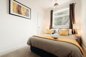 a bedroom with a large bed with a window at K Suites - Station Road 13 in Hinckley