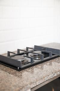 a stove top oven sitting on top of a counter at Zar Hotel in Amanzimtoti +51 photos