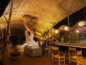a restaurant with a large ceiling with a large sculpture at Marbela Beach Resort in Morjim +94 photos