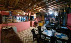 a room with tables and chairs in a restaurant at Rancho e Pesqueiro do Cowboy in Piedade