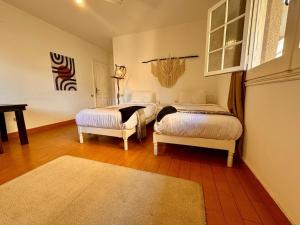 a bedroom with two beds and a rug at Villa Maadi 35 - R 205- Pool View Room in Cairo