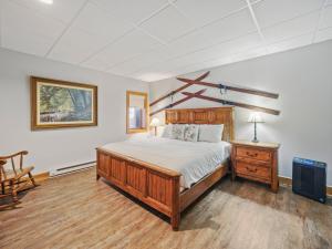 a bedroom with a bed and a tv in it at 692 Disciples Village Condo in Boyne Falls