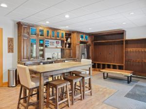 a kitchen with a large wooden table and chairs at 692 Disciples Village Condo in Boyne Falls
