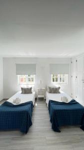 two beds in a room with white walls at Old Village in Vilamoura +195 photos