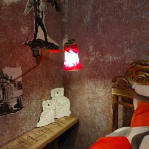 a room with a lamp and a bed and a wall at Crystal Ball Residency in Berlin