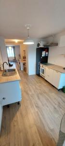 a room with a kitchen with a sink and a counter at Sous les toits de Béthune in Béthune +8 photos