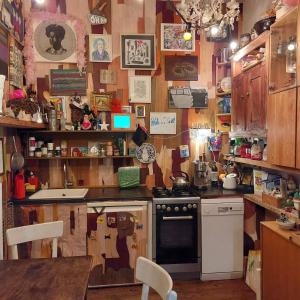 a cluttered kitchen with a stove and a sink at Crystal Ball Residency in Berlin +8 photos
