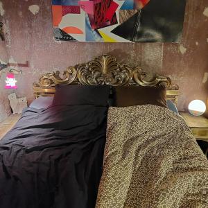 a bed with a ornate headboard in a bedroom at Crystal Ball Residency in Berlin