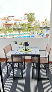 a table and chairs on a balcony with a view at Old Village in Vilamoura