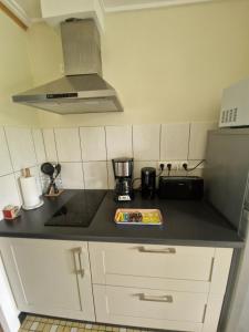 a kitchen with a black counter top with a blender at Montignac, t2 proche Lascaux in Montignac