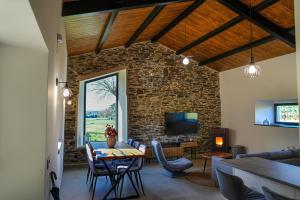 a living room with a stone wall at Casa Rural Lugar Vista Alegre in Lugo