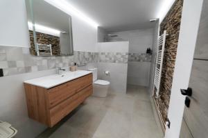 a bathroom with a sink and a toilet and a mirror at Casa Rural Lugar Vista Alegre in Lugo +17 photos
