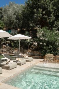 a swimming pool with chairs and umbrellas next to a swimming pool at Tenuta dei Normanni in Salerno