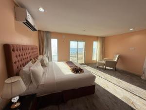 a hotel room with a bed and a large window at فندق ستارفيش الحوراء الفندقية in Umm Lajj