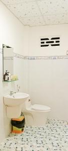 a bathroom with a toilet and a sink at Đức Phát Homestay in Tân Phú