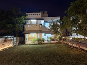 a large house at night with a yard at Lila Niwas in Udaipur