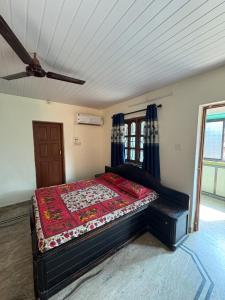 a bedroom with a bed in a room with a ceiling at Virens Heaven Stays in Calangute