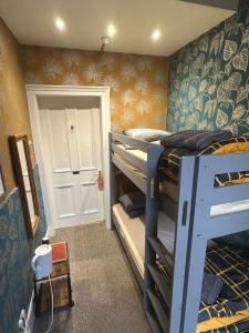 a room with two bunk beds and a door at IVY House in Edinburgh