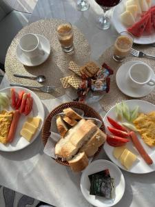 a white table with plates of food on it at Argymak Hotel Karakol in Karakol