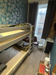 a bedroom with two bunk beds and a window at IVY House in Edinburgh +12 photos