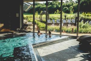 two children are swimming in a swimming pool at Ramside Hall Hotel, Golf & Spa in Durham +26 photos