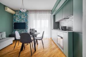 a kitchen and living room with a table and chairs at Assago Forum Apt - 3 min Walk in Assago +21 photos