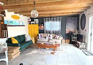 a living room with a couch and a coffee table at The Boathouse in Velddrif