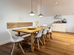 a dining room with a wooden table and chairs at Agroturystyka Kaczor nad jeziorem in Męcidół