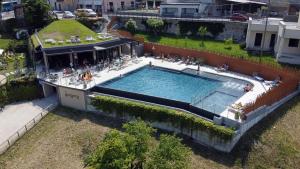 an overhead view of a swimming pool on a building at Stella D'Oro - Hotel & Apartments in Tremosine Sul Garda +75 photos