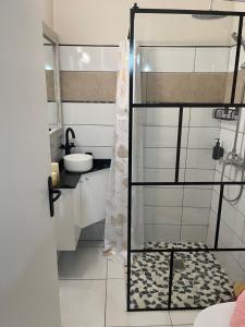 a bathroom with a shower and a sink at Milles Eclats in Les Anses-dʼArlets +16 photos