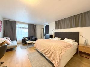 a bedroom with a large bed and a living room at Hótel Dalvík in Dalvík