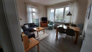 a living room with a couch and a table at Ferienwohnung Möwe in Dornum