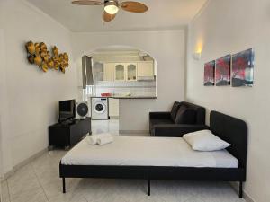 a living room with a bed and a couch at Blife Martya apartment in Olhão