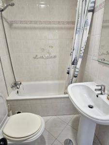 a bathroom with a toilet and a sink at Blife Martya apartment in Olhão