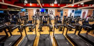 a gym with rows of tread machines at Hotel Olympia Valencia in Alboraya