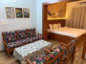 a small room with a bed and a couch at Lila Niwas in Udaipur