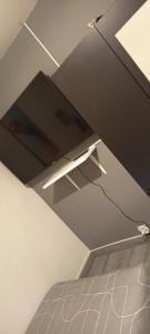 a tv on a shelf in a room at Chambre double avec lit clic clac in Saint-Pardoux-Isaac +3 photos