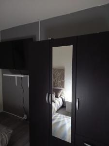 a mirror in a room with a bed at Chambre double avec lit clic clac in Saint-Pardoux-Isaac