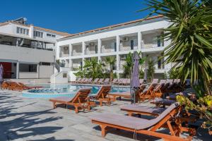 a hotel with lounge chairs and a swimming pool at Mojo Hotel Laganas Zante in Laganas